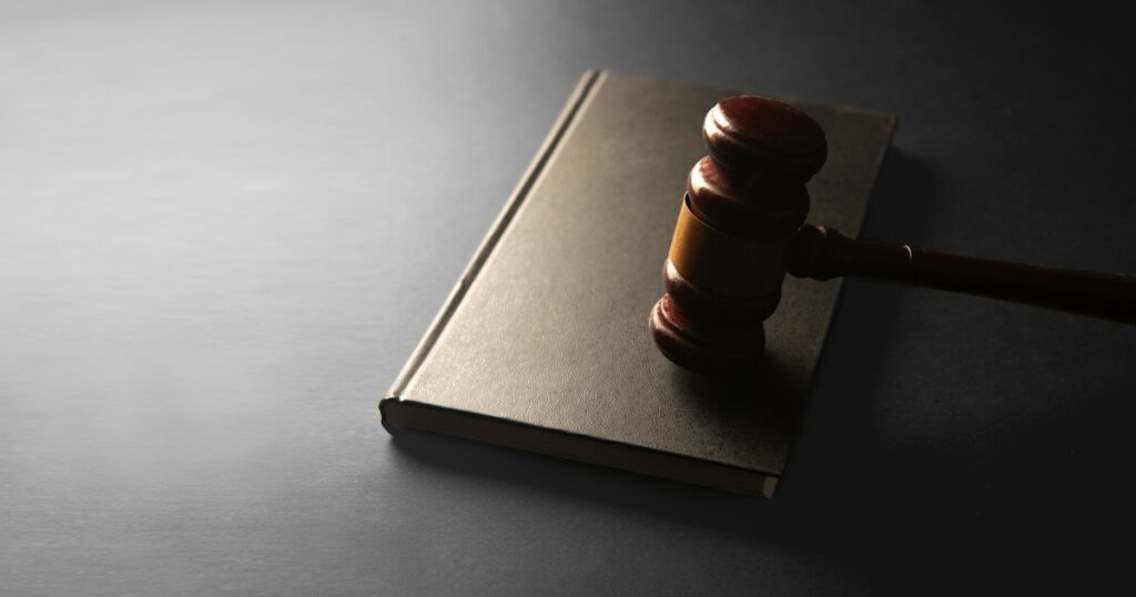 Wooden gavel resting on a closed book